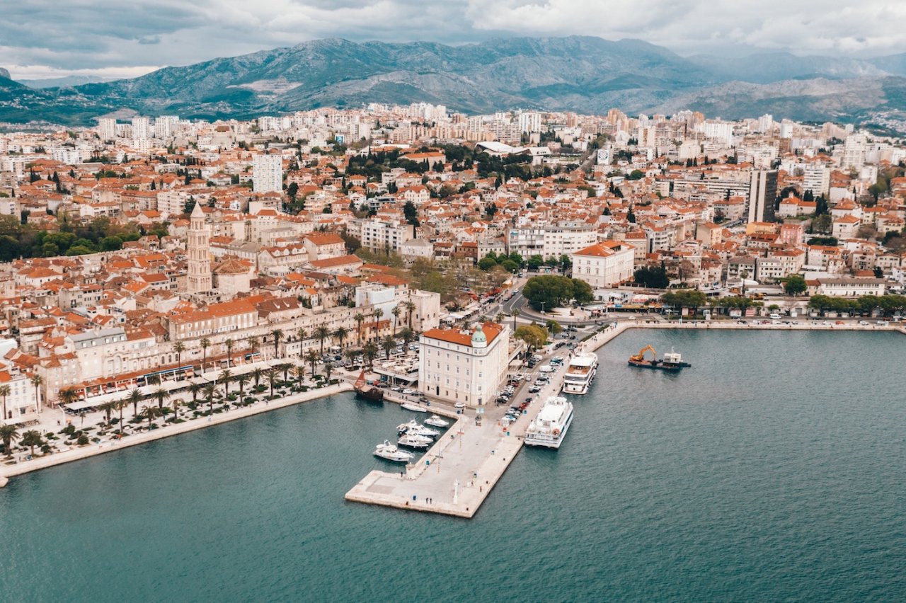 Aerial view of Split, Croatia showing the port, beautiful mountain landscape and the terracotta roofs of Split