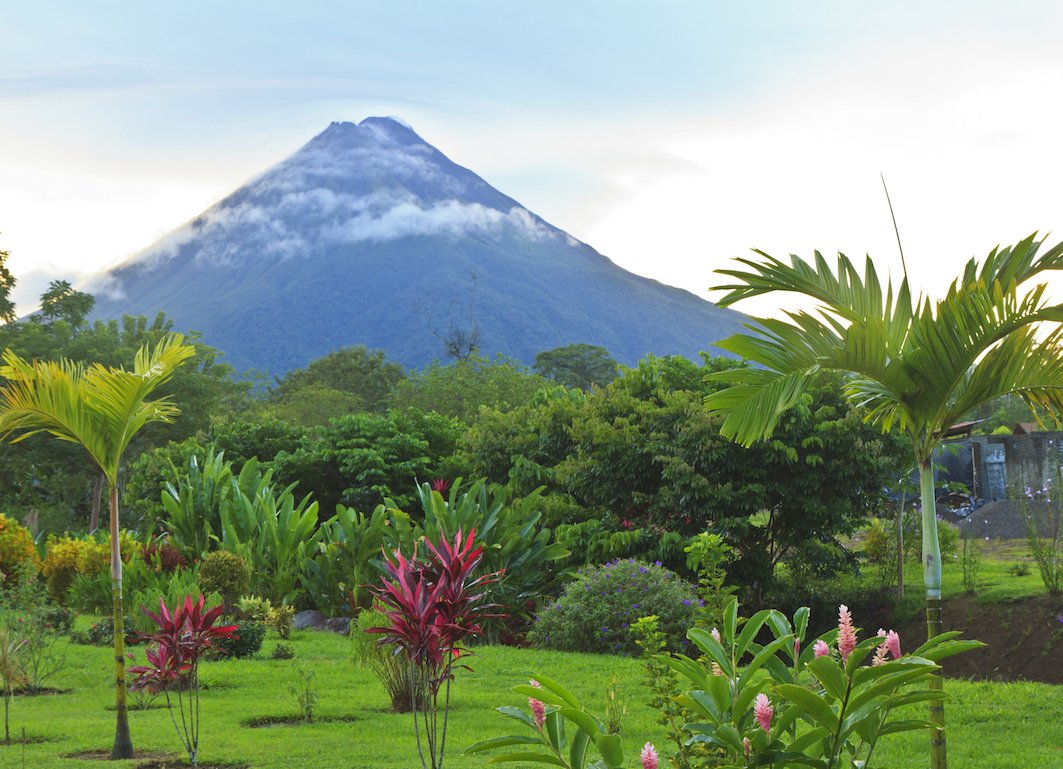 View of areal volcano with trees and grass