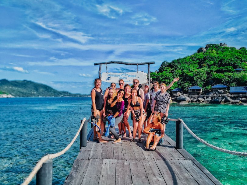 A group photo in Koh Tao by the clear blue water